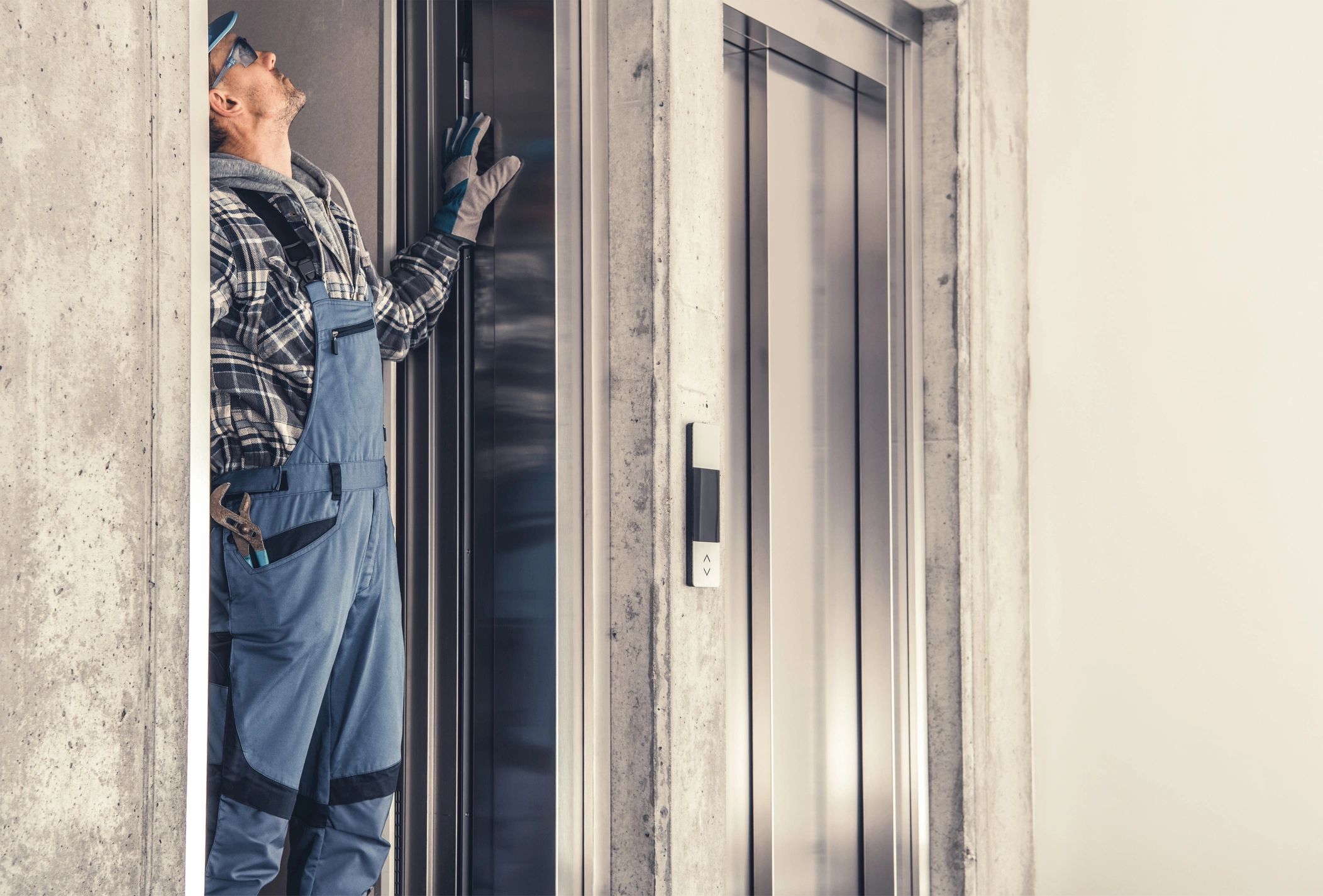 Caucasian Residential Elevator Technician in His 40s Performing